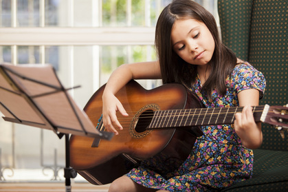 Girl practicing guitar